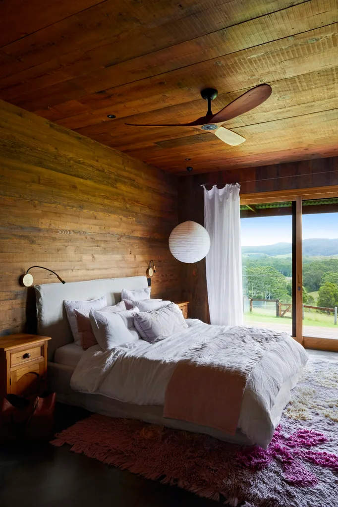 Timber bedroom with views of the countryside.