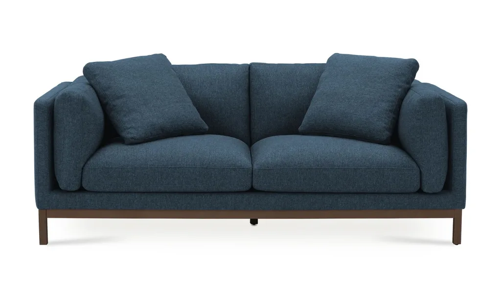 A blue couch with cushioned back and sides, perfect for winter decorating