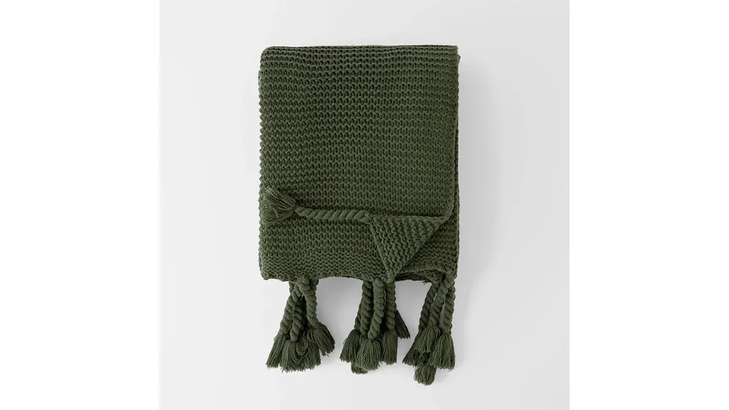 A green throw blanket, perfect for winter decorating