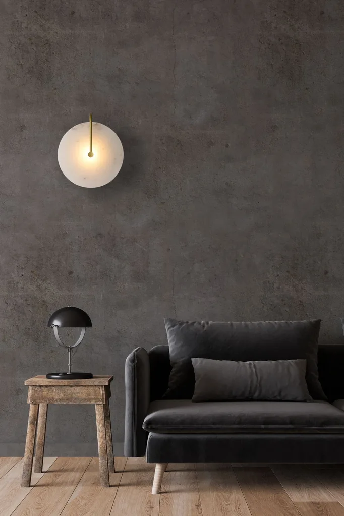 Alabaster wall sconce light in living room with sofa