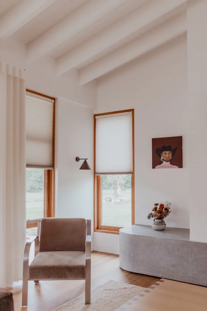 Luxaflex roller blinds on a window keep the room warm in winter and cool in summer.