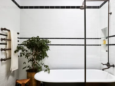 A claw foot bath in a 1920s inspired art deco bathroom.