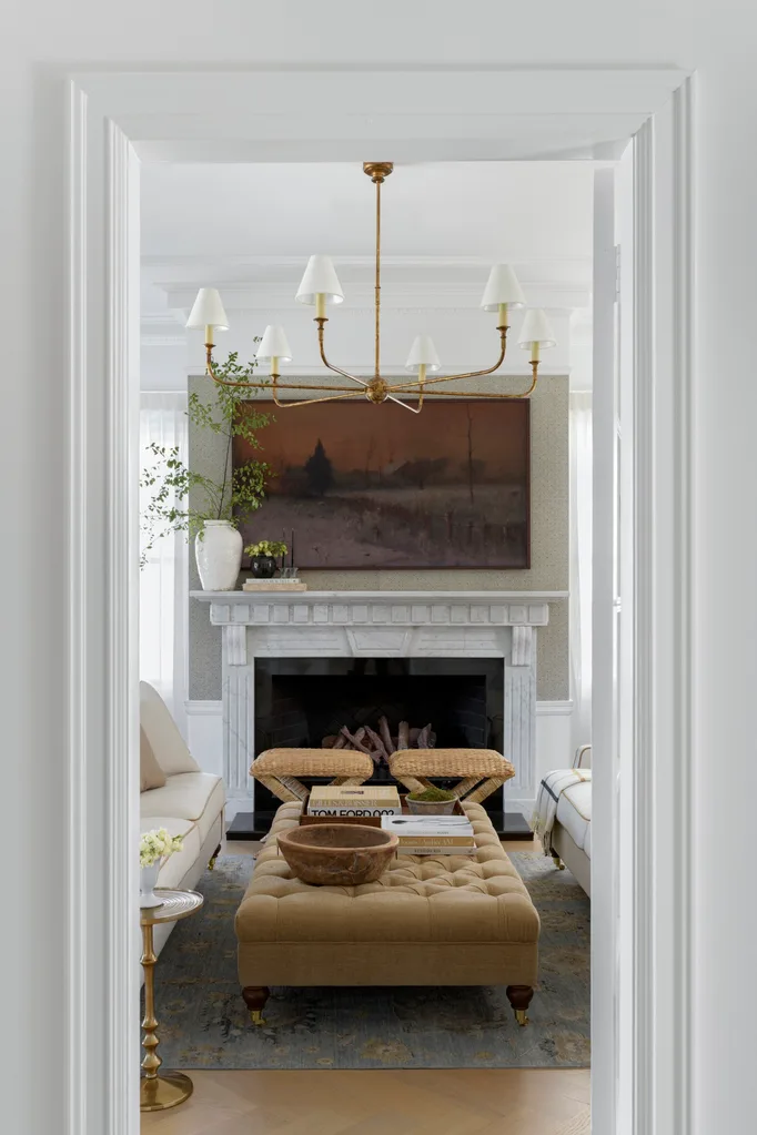 Living room from the Brisbane project, with a gold pendant, fireplace and neutral tones