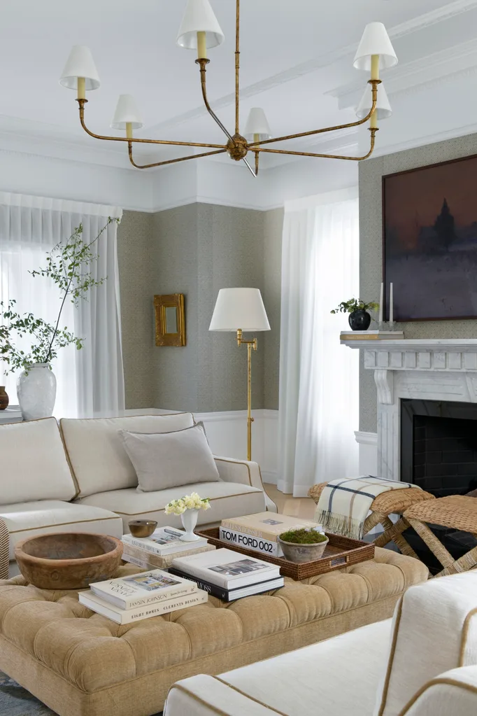 Living room from the Brisbane project, with a gold pendant, fireplace and neutral tones