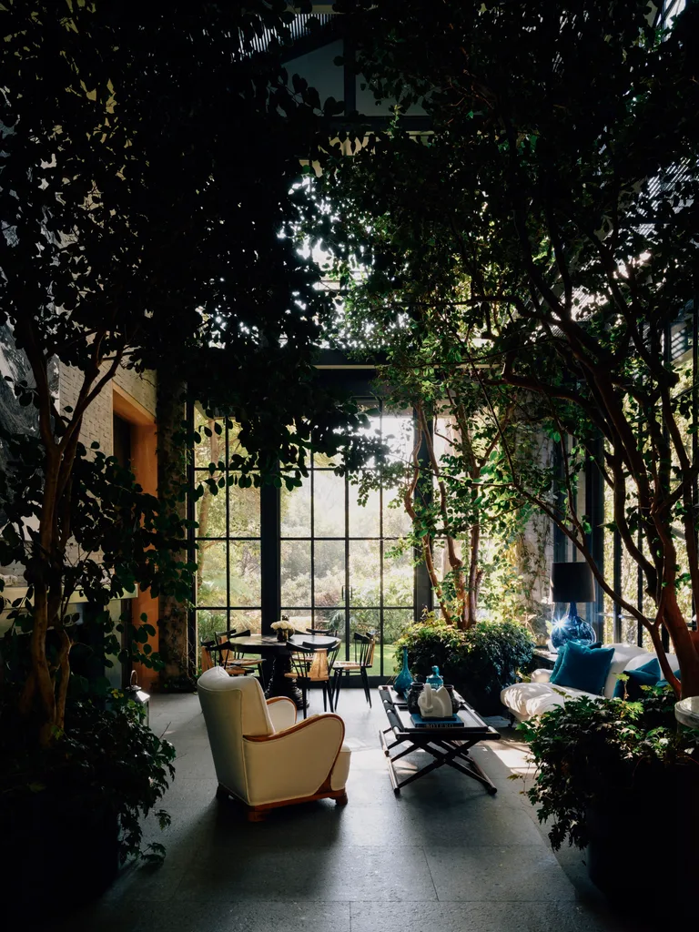 An indoor conservatory full of plants.
