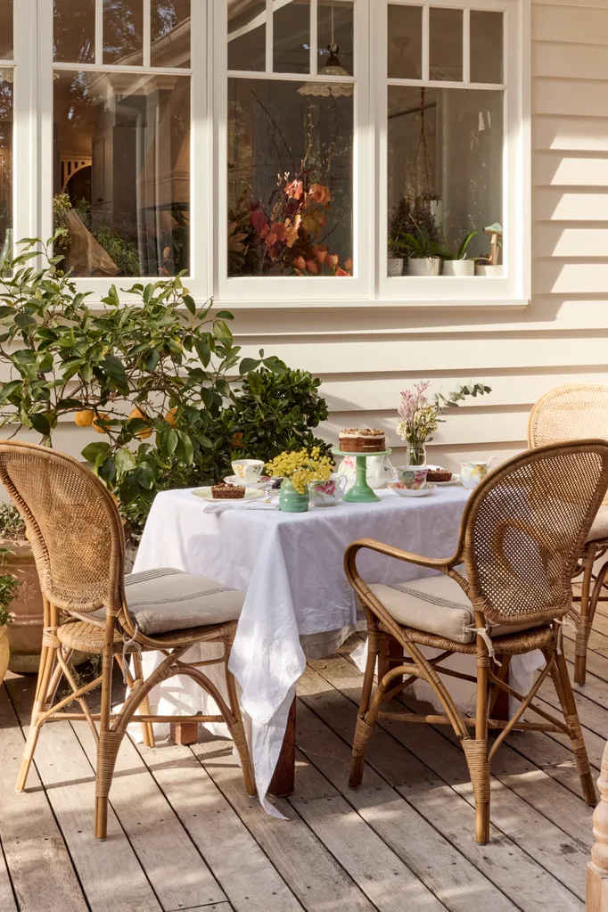 Miranda Kerr x Royal Albert pieces styled on a table with a weatherboard home in background