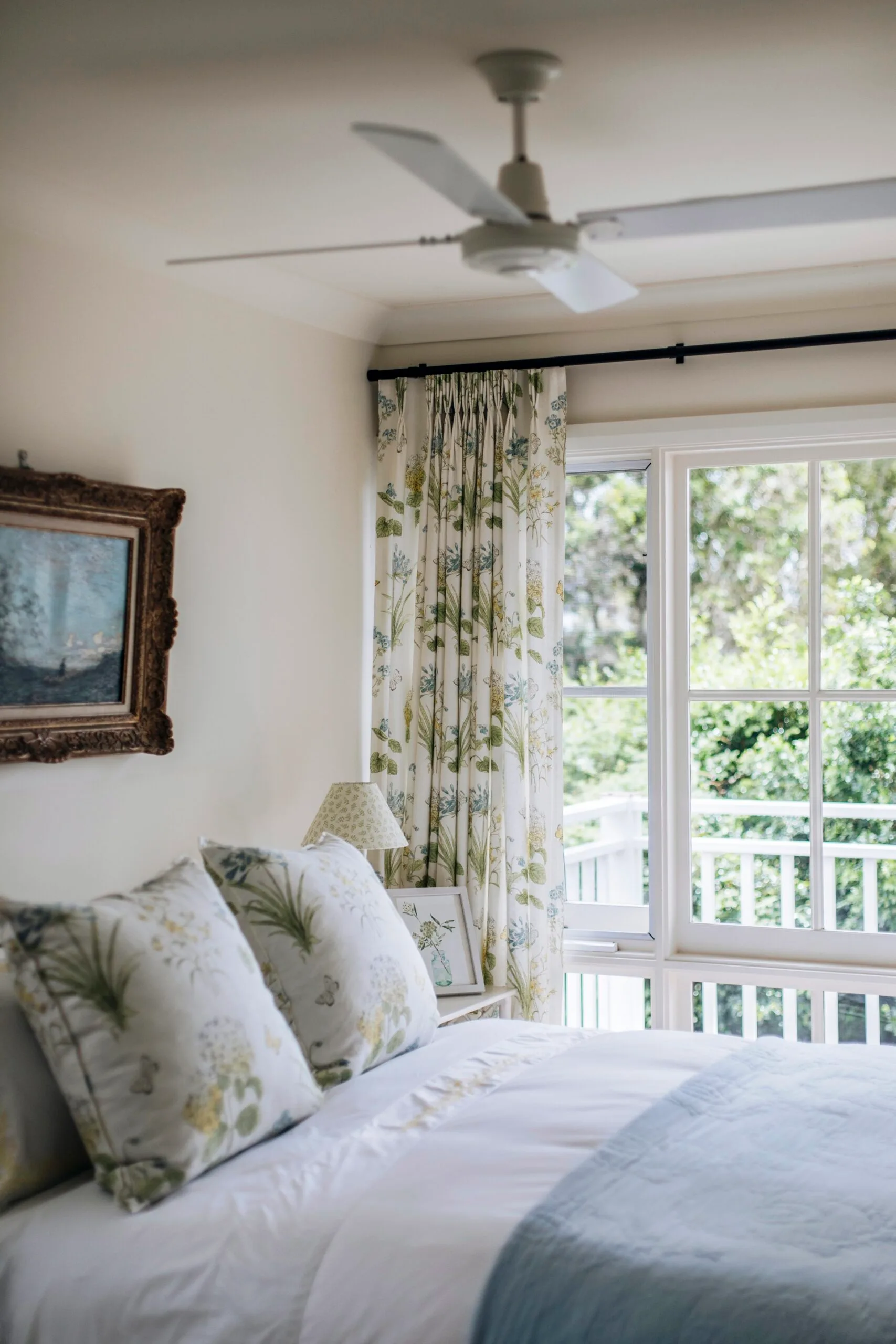 A blue and green bedroom looking out to a balcony. 