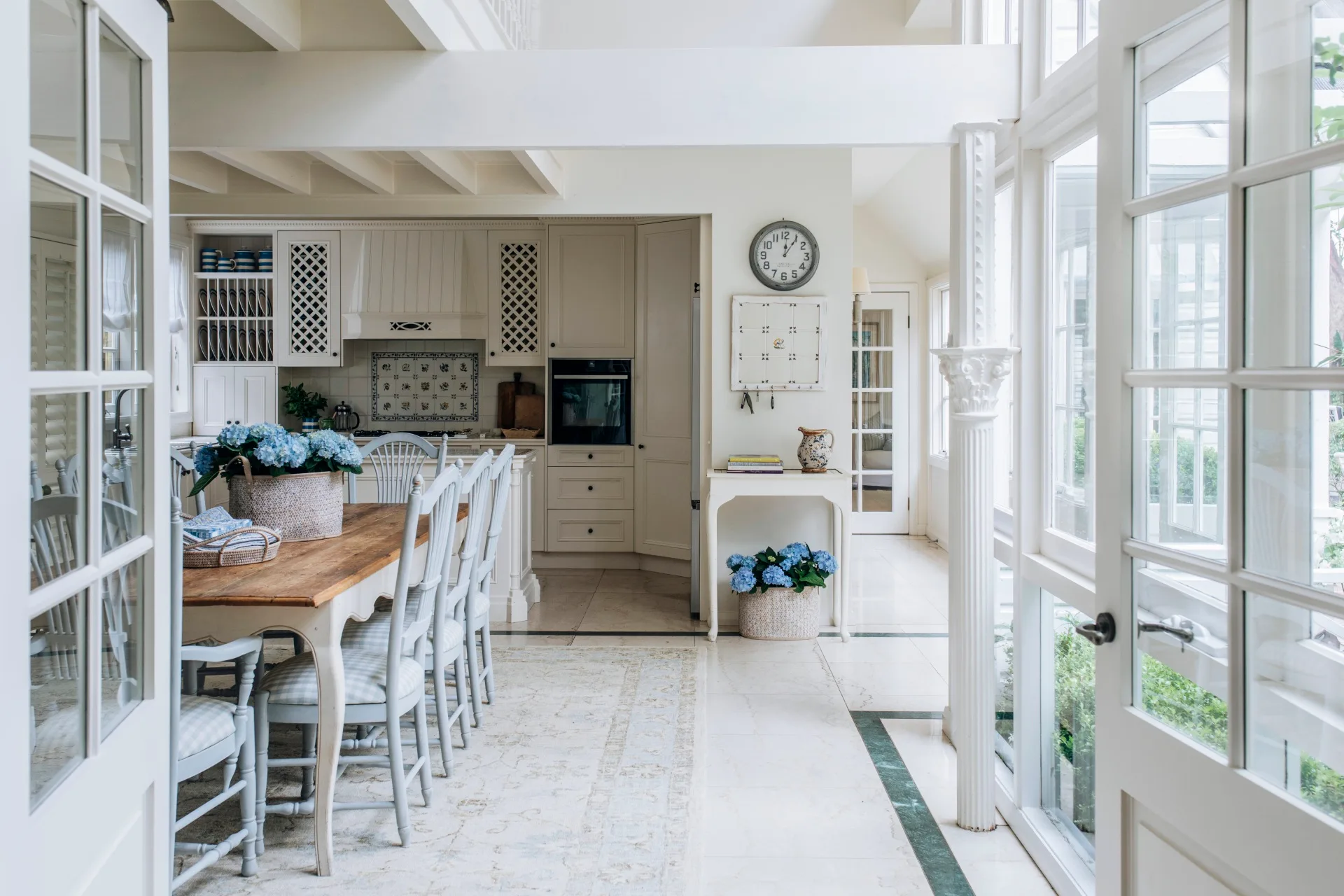 French doors open to the character filled dining room in this Nantucket style home. 