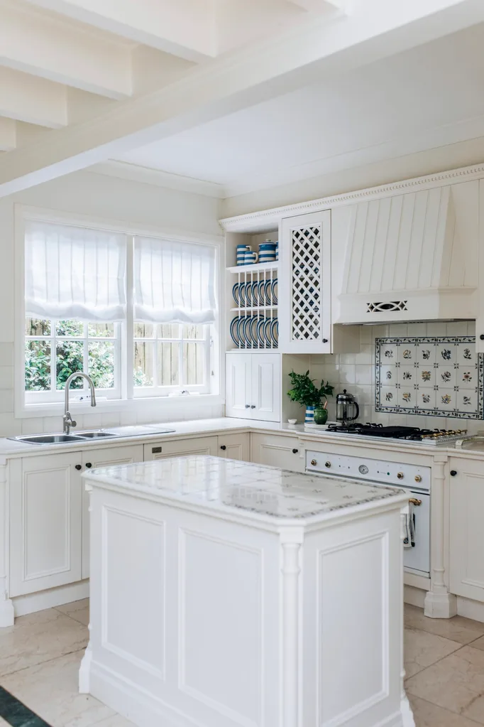 A kitchen island inside a white kitchen.