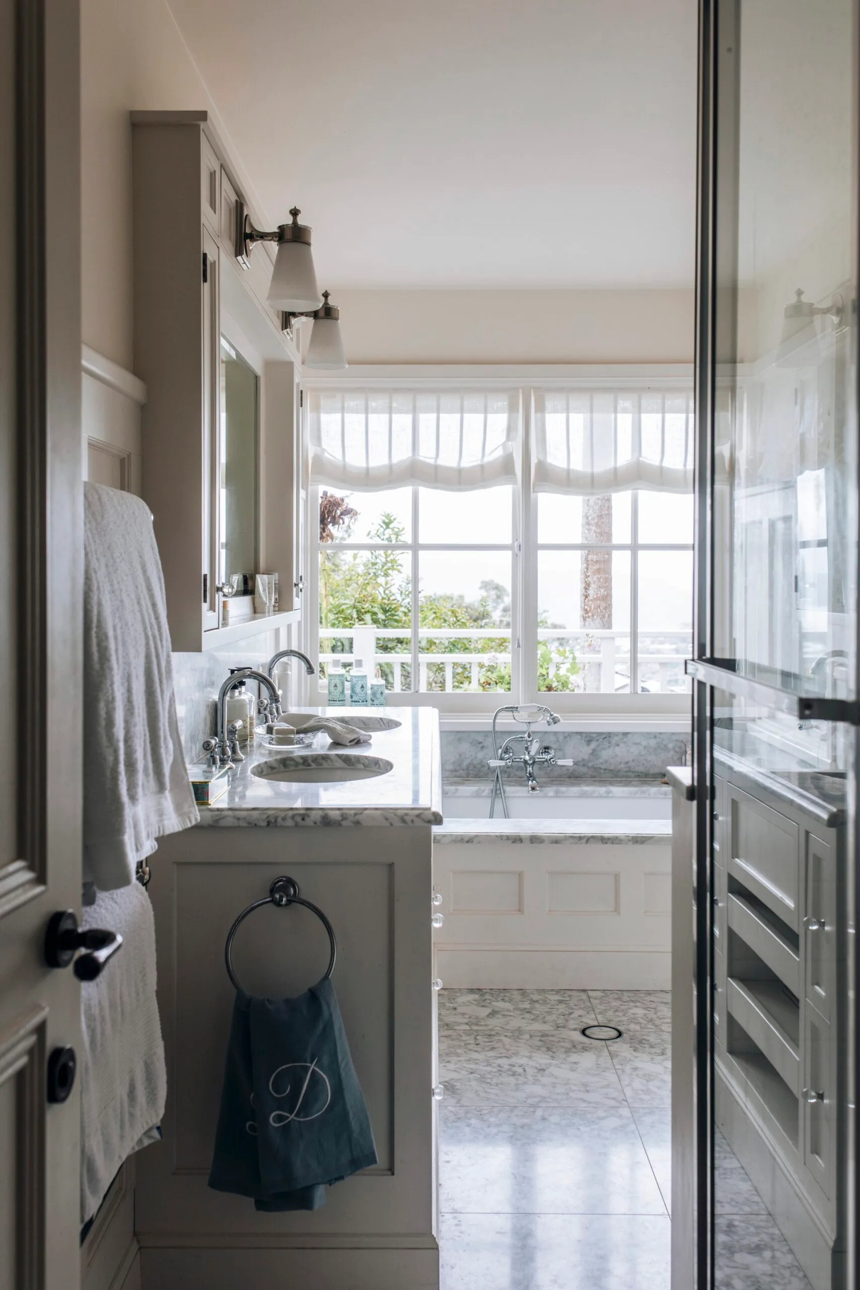Grey-veined marble bathroom in a Nantucket home. 