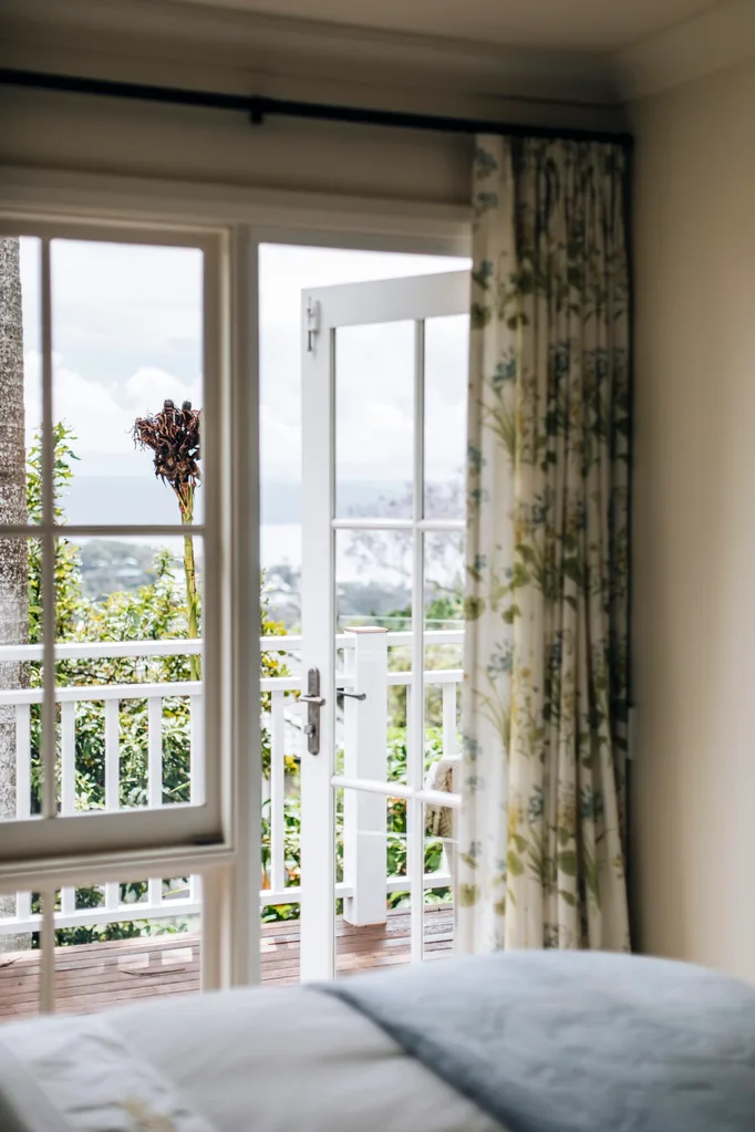 A bedroom window opening onto a balcony.