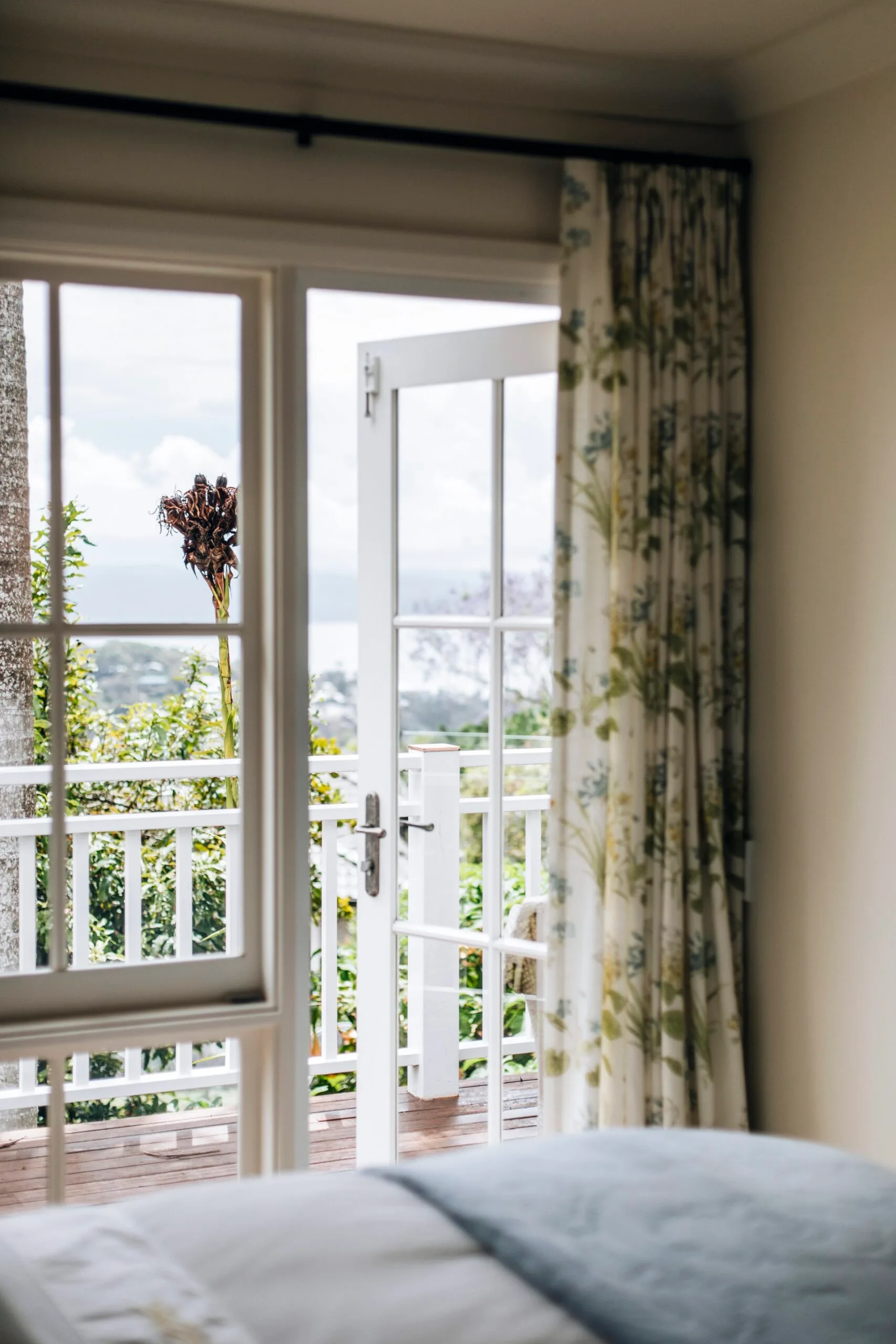 A bedroom window opening onto a balcony. 