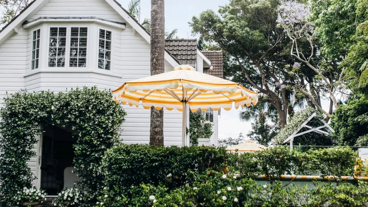 A tropical entrance to a Nantucket style home in Palm Beach.