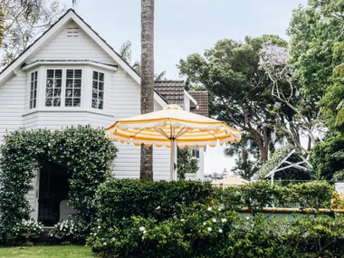 A tropical entrance to a Nantucket style home in Palm Beach.