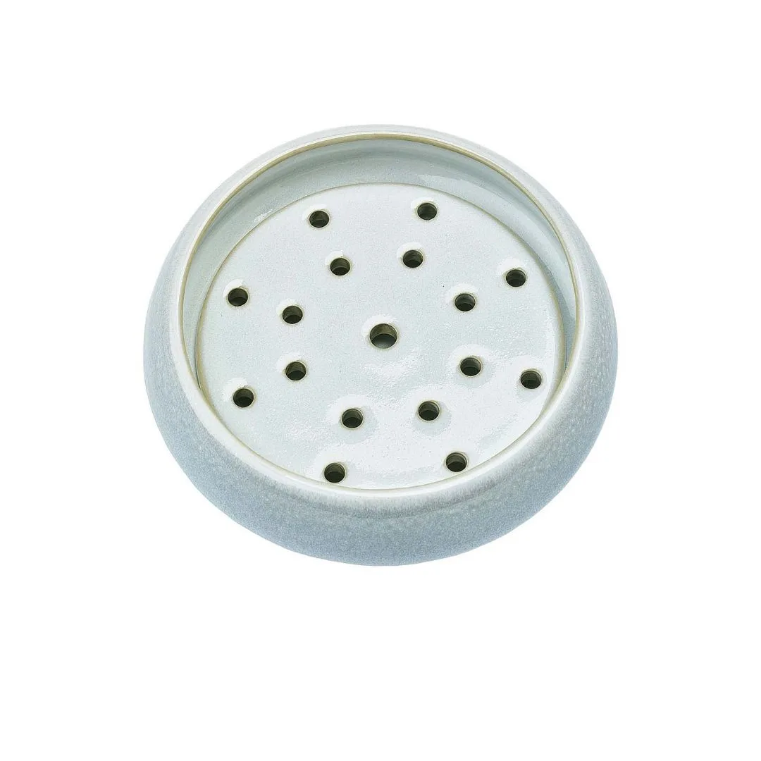 A blue circular soap dish with draining holes. 