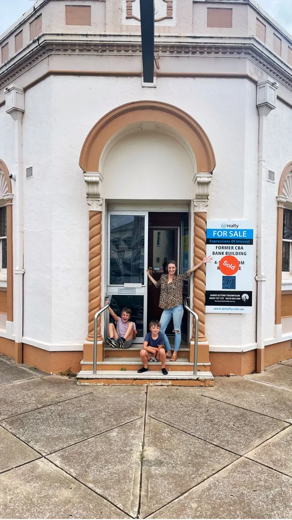 The sold sign on the old bank building.