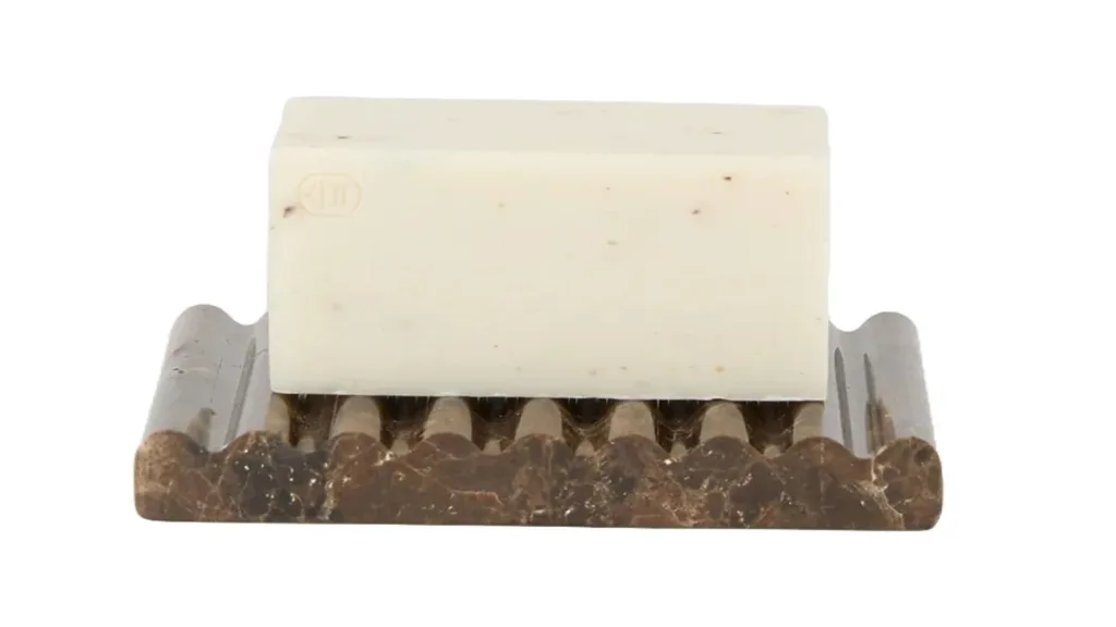 A marble soap dish made out of earth tones with opaque, glossy black stone