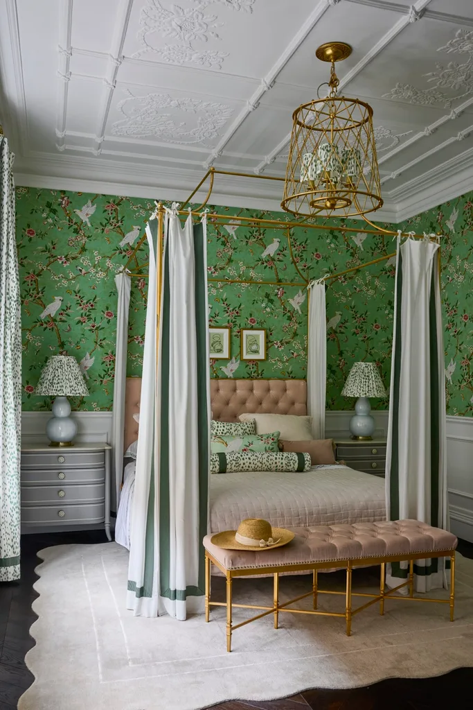 Green patterned wallpaper and a four poster bed inside the bedroom of a Sydney heritage home.