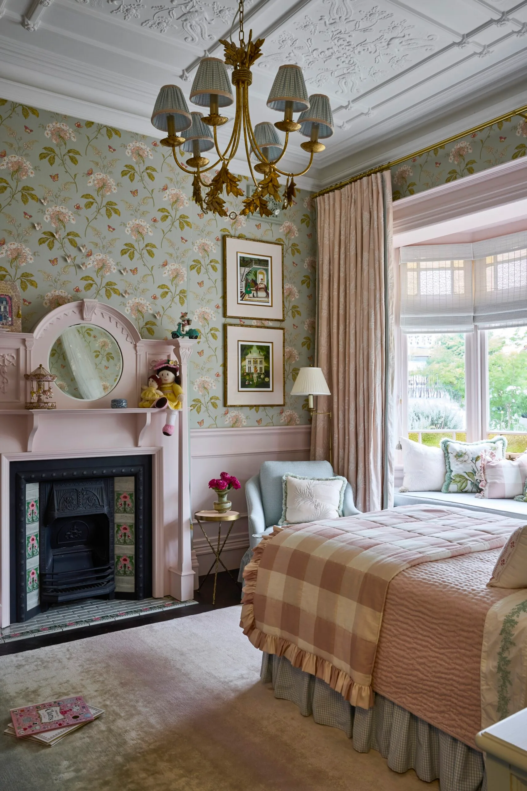 A pink and green patterned young girl's bedroom. 