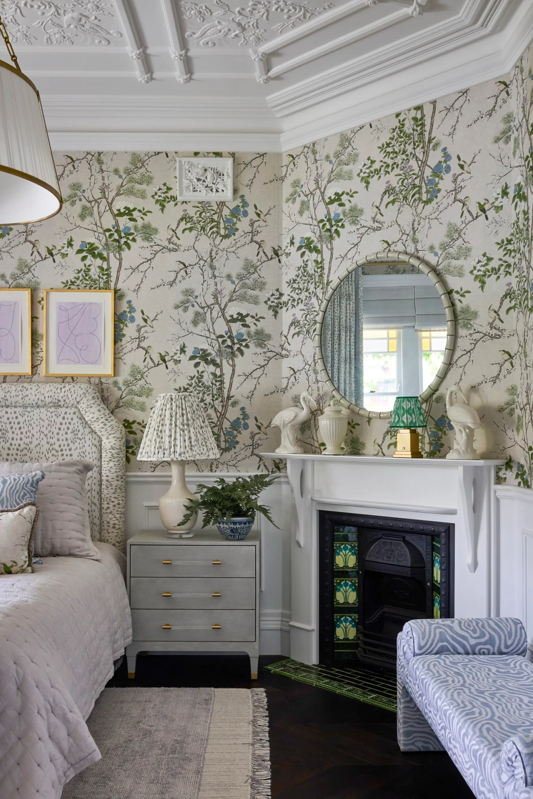 A bedroom with patterned wallpaper and a fireplace inside a Sydney heritage home in the Inner West. 