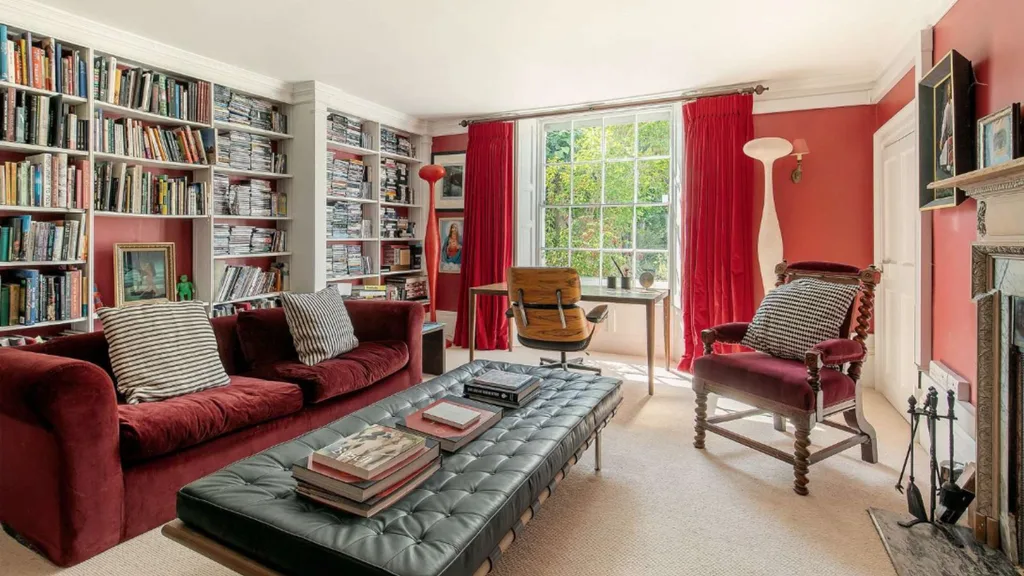 Tim Burton's red living room filled with books.