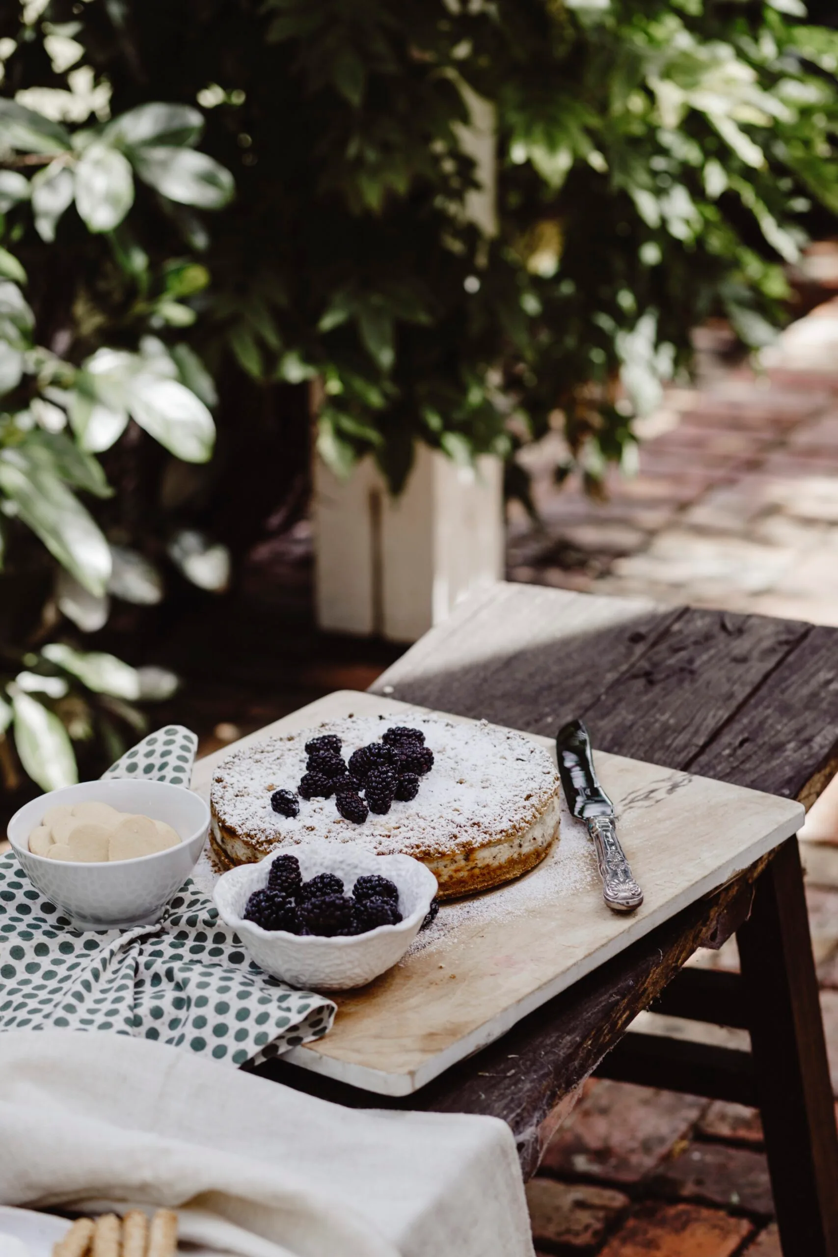 A cake on a rustic outdoor table. 