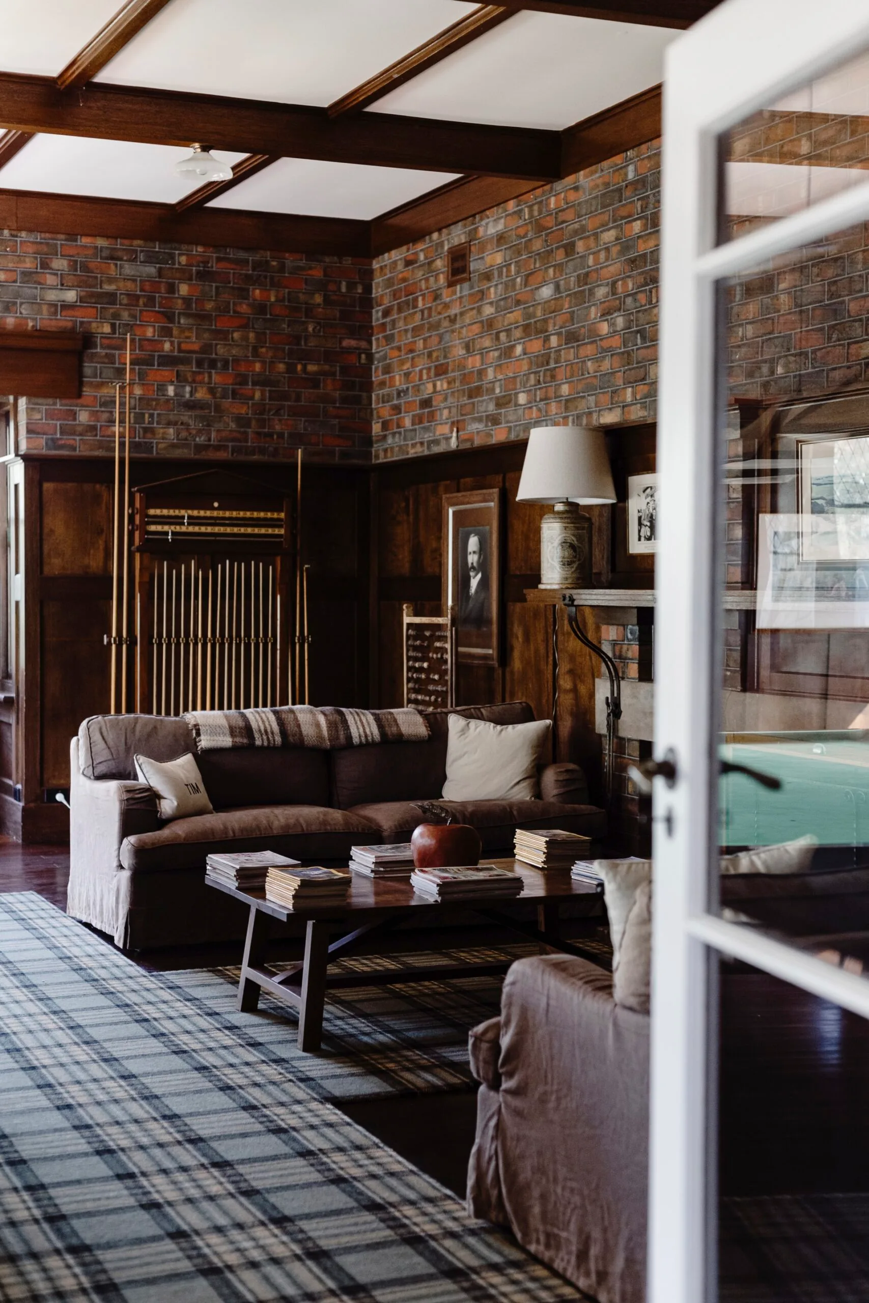 Dark and moody country living room with brick walls. 