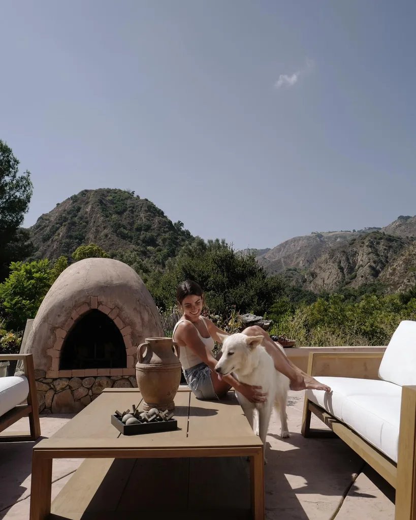 Twilight star Nikki Reed at home on her California ranch outdoors with dog