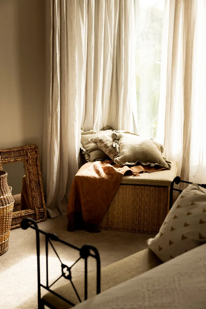 Ratan decor and curtains in a cosy bedroom.
