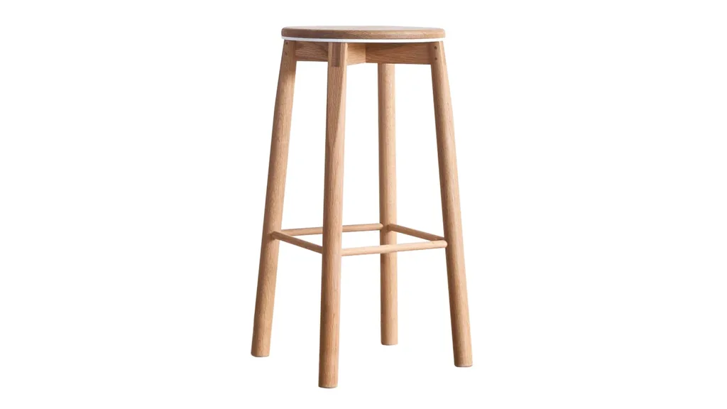 A bar stool with a circular seat and leg rests.