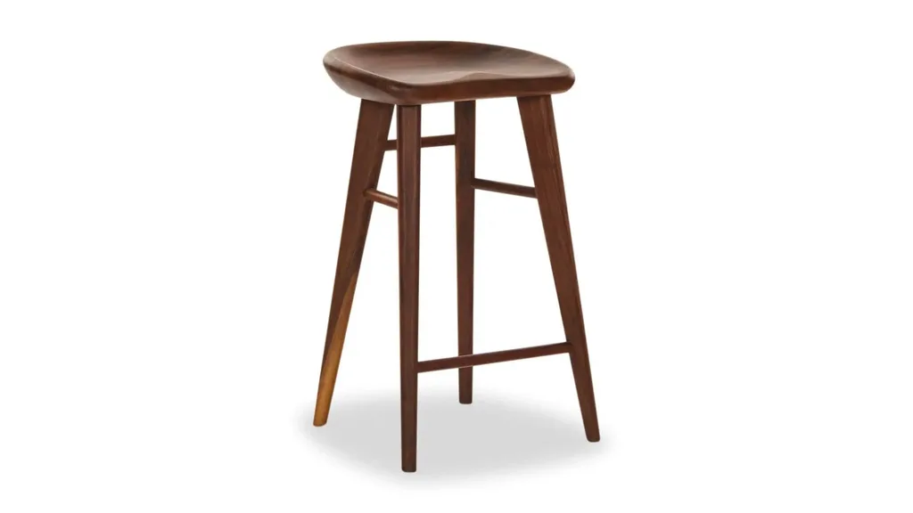 A bar stool in a deep walnut with leg rests and a curved seat.