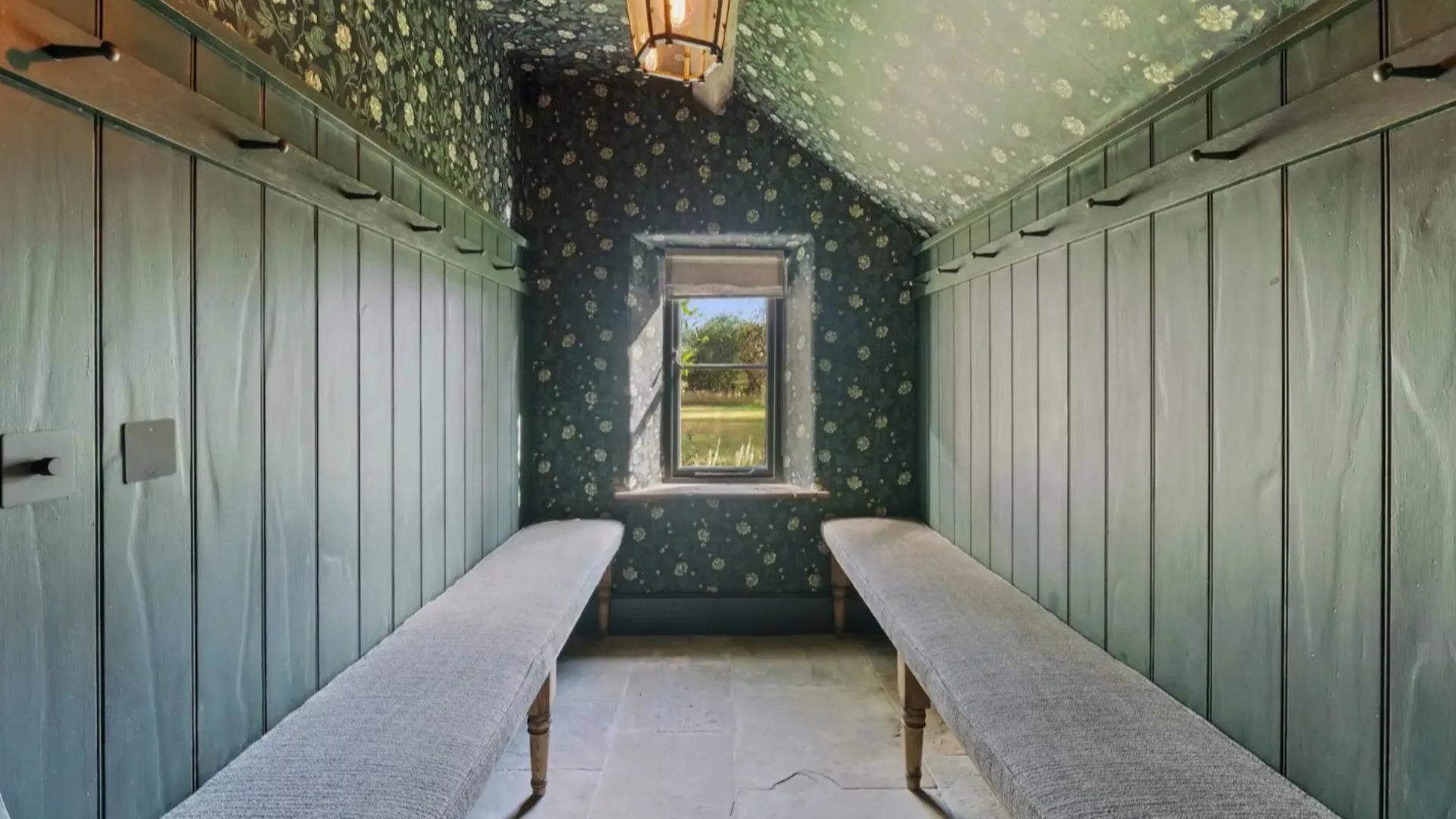 Ellen Degeneres storage/mud room with wallpaper. 