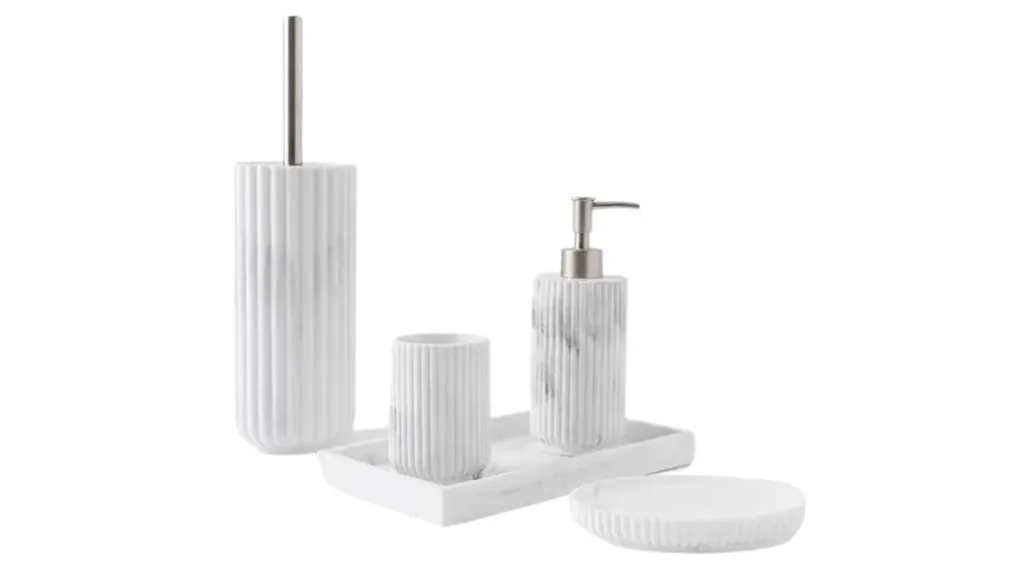 A bathroom accessory set including a toilet brush and holder, toothbrush holder, soap dispenser and tray, all with matching ridged pattern with a marble-look finish.
