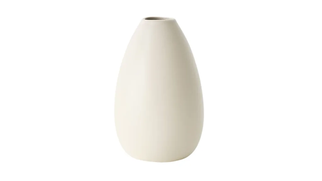 A cream coloured ceramic vase in a teardrop shape.