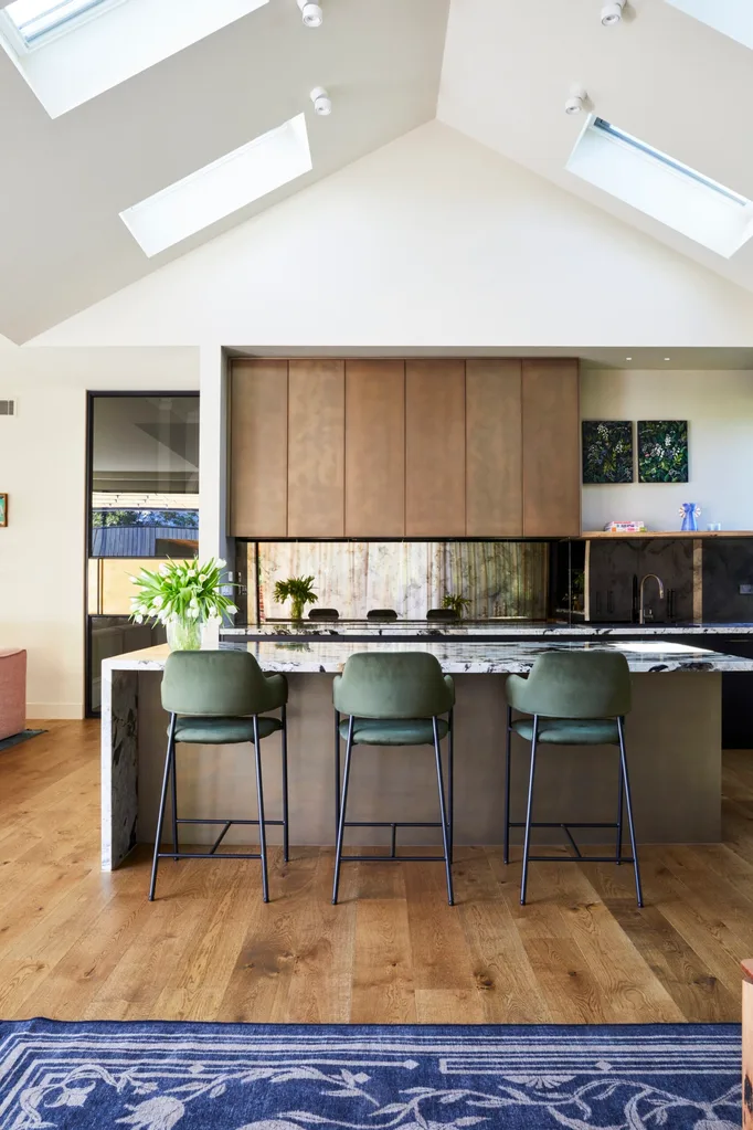 The kitchen in Fleur Harris' home features a brass splashback and brass joinery.