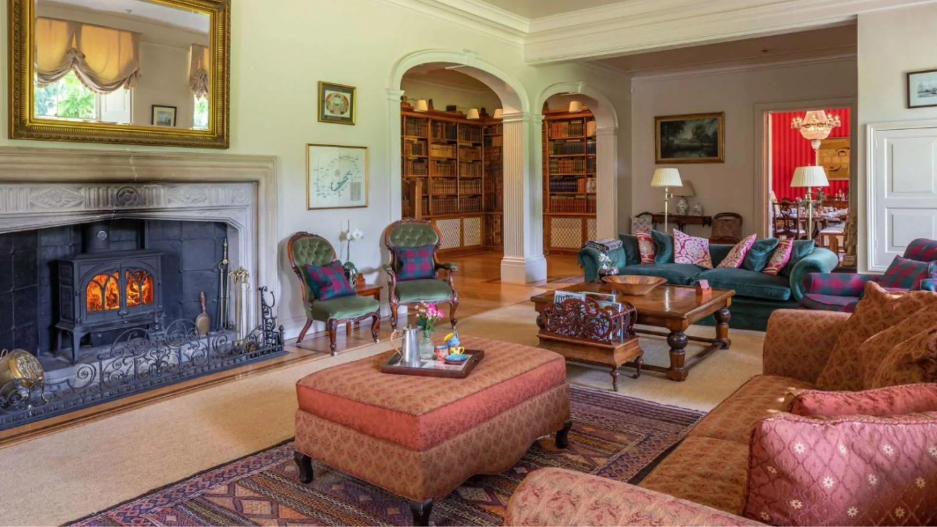 Mel B's living room with a fireplace and ottoman.