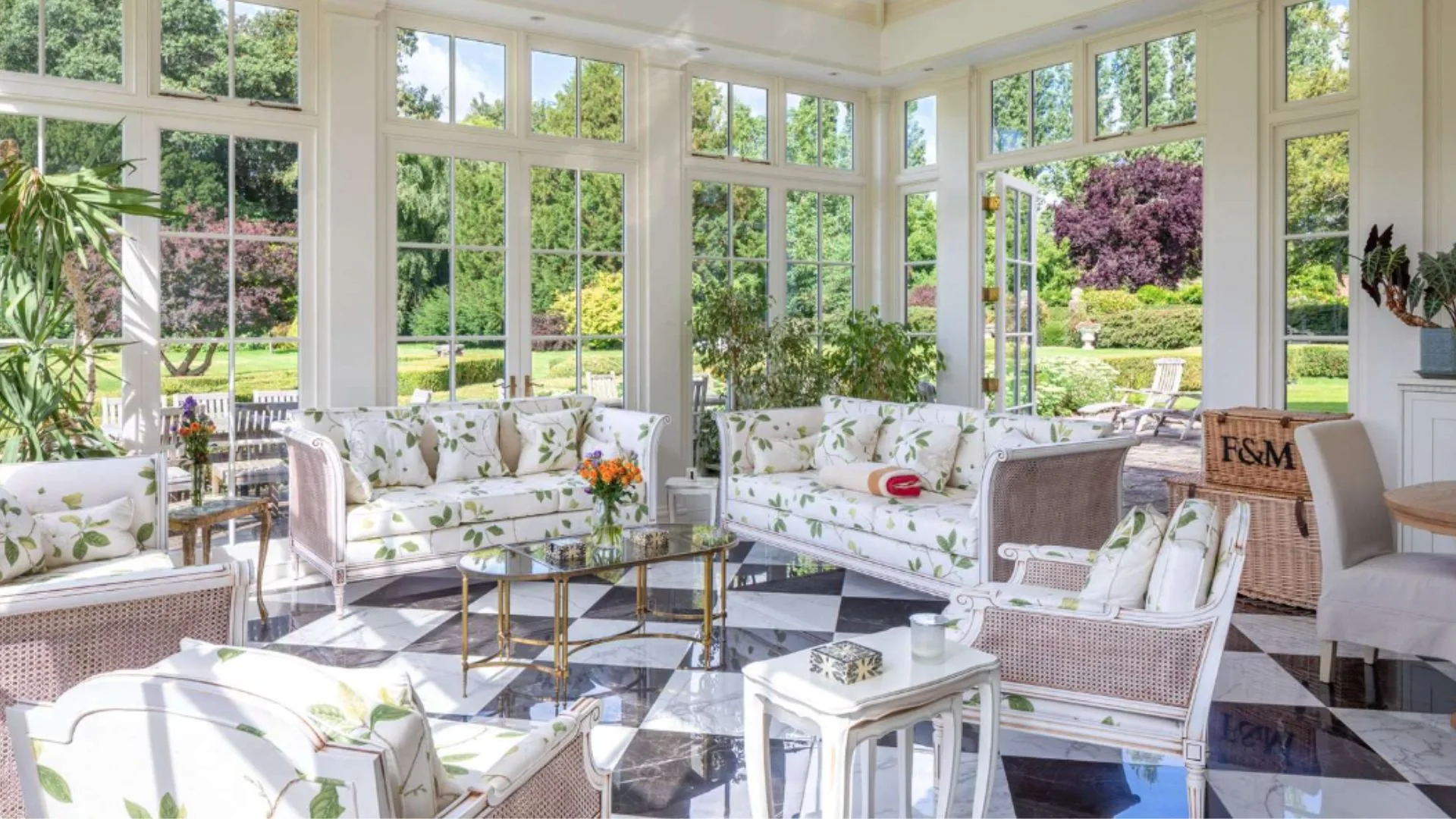 Mel B's sunroom with floral green furniture and checkerboard floors. 
