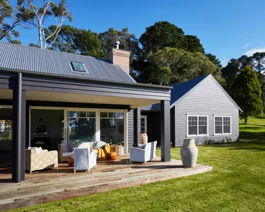 The exterior of a modern farmhouse on the Mornington Peninsula and its back deck.