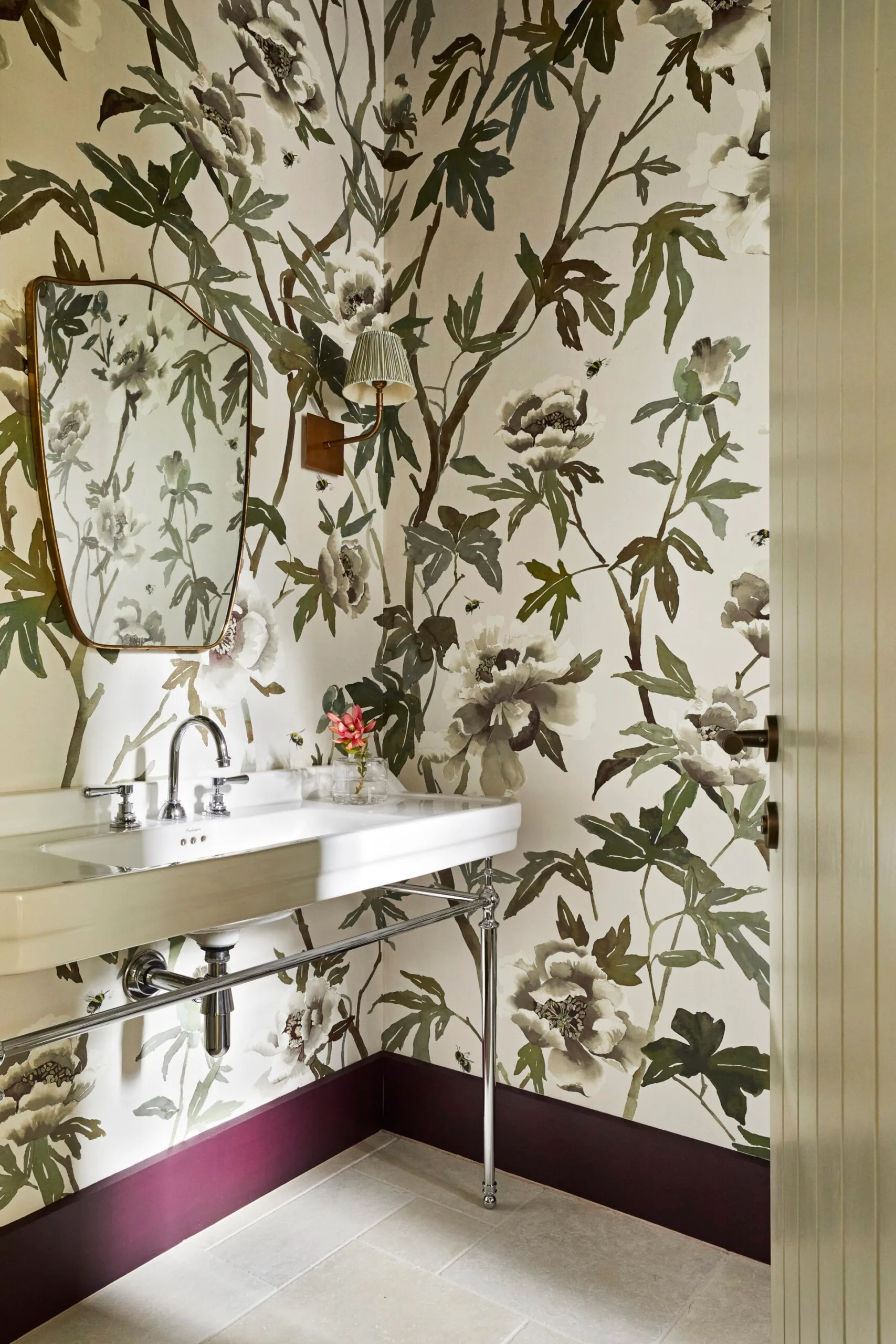 A floral, wallpapered powder room. 