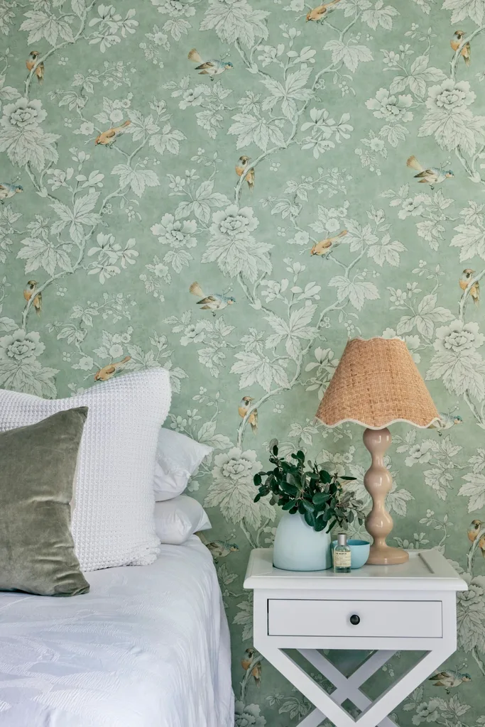Green wallpaper in renovated bedroom.