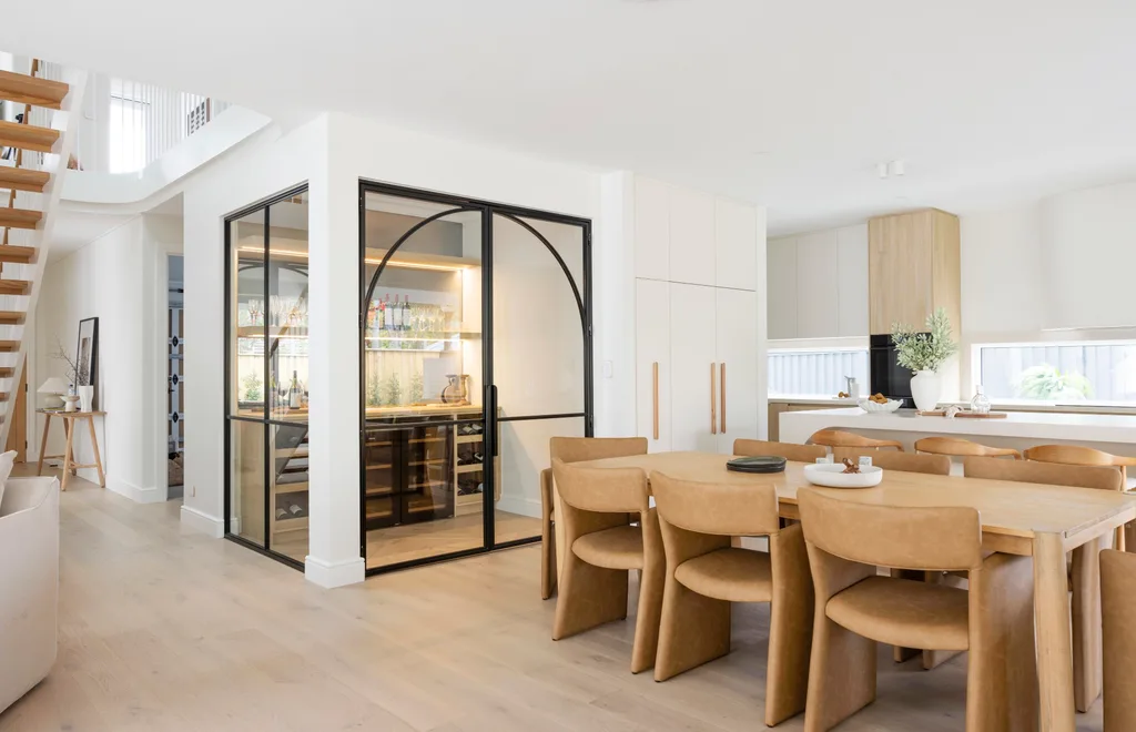 The open plan kitchen, dining and wine room inside a Oak and Orange new build.