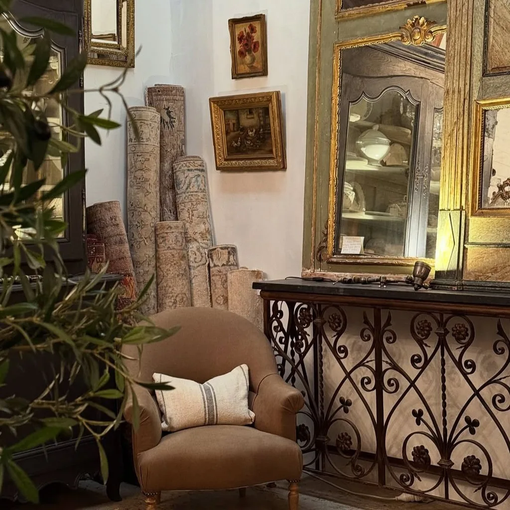 A selection of rugs, mirrors and an armchair inside the Sydney Antique Store, Shades of Pale