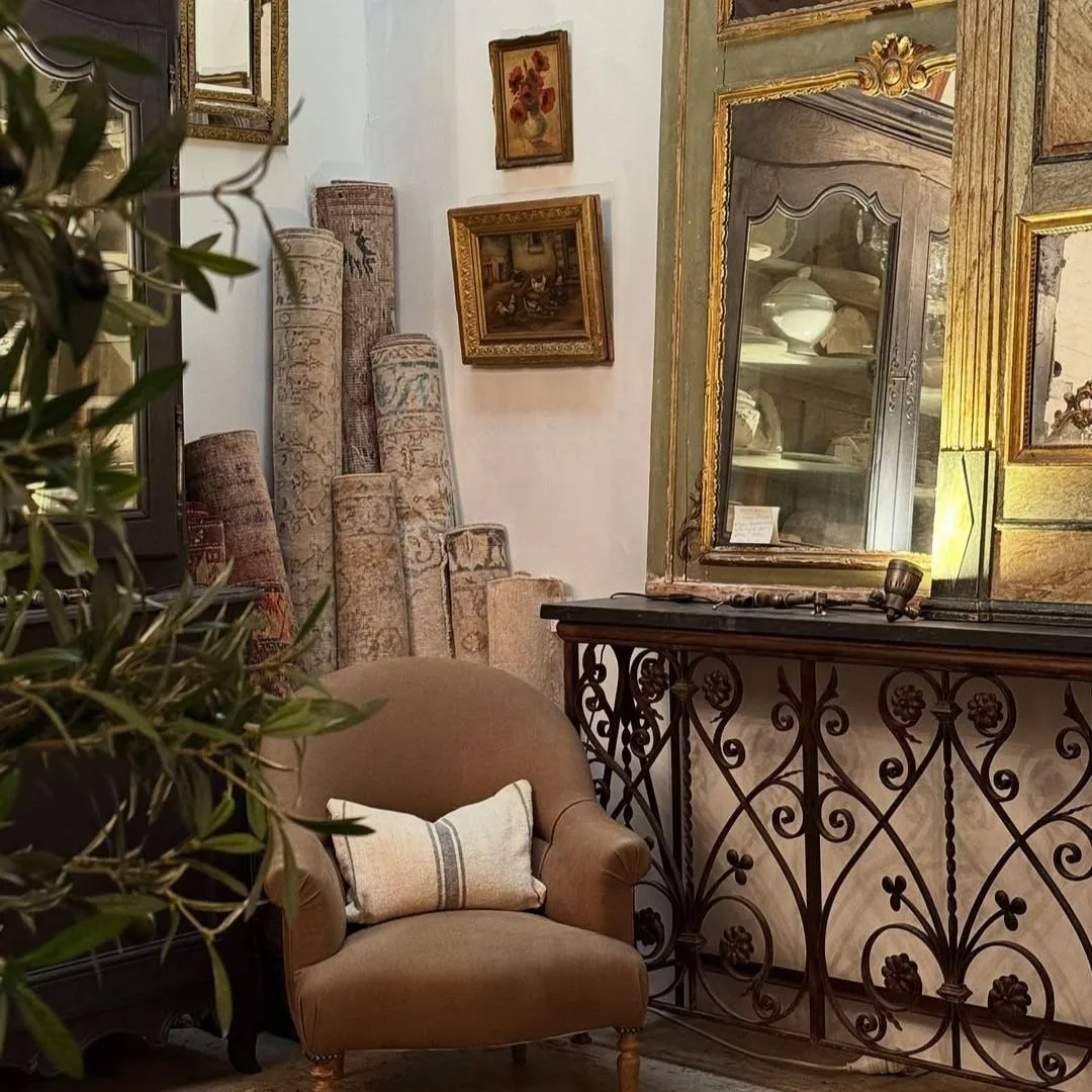 A selection of rugs, mirrors and an armchair inside the Sydney Antique Store, Shades of Pale 