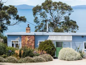 Colourful interiors and striking sea views envelop this Tasmanian Airbnb
