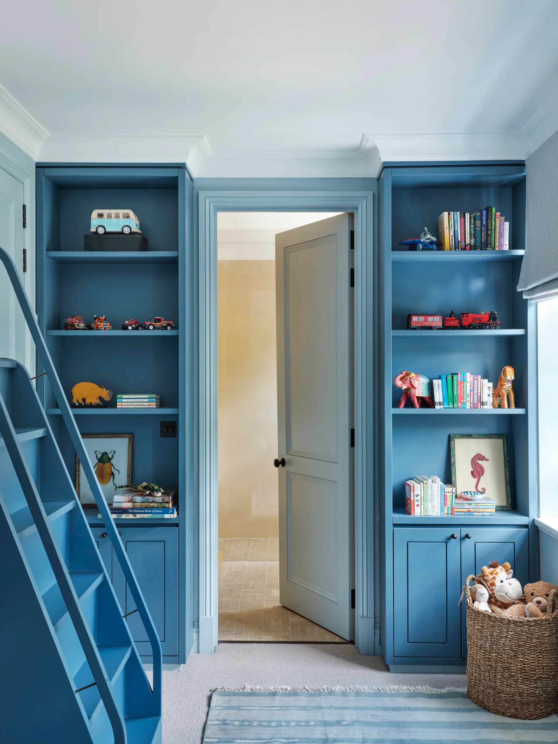Built in shelving and an ensuite bathroom in a child's bedroom. 