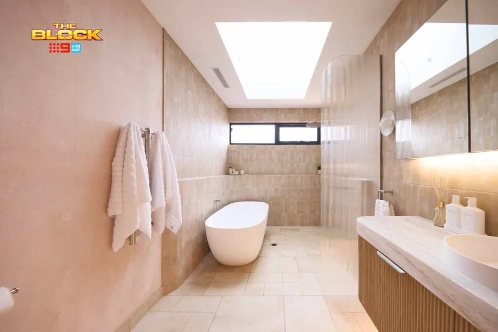 Britt and Taz's bathroom from the Block with a free standing bath and curved shower.