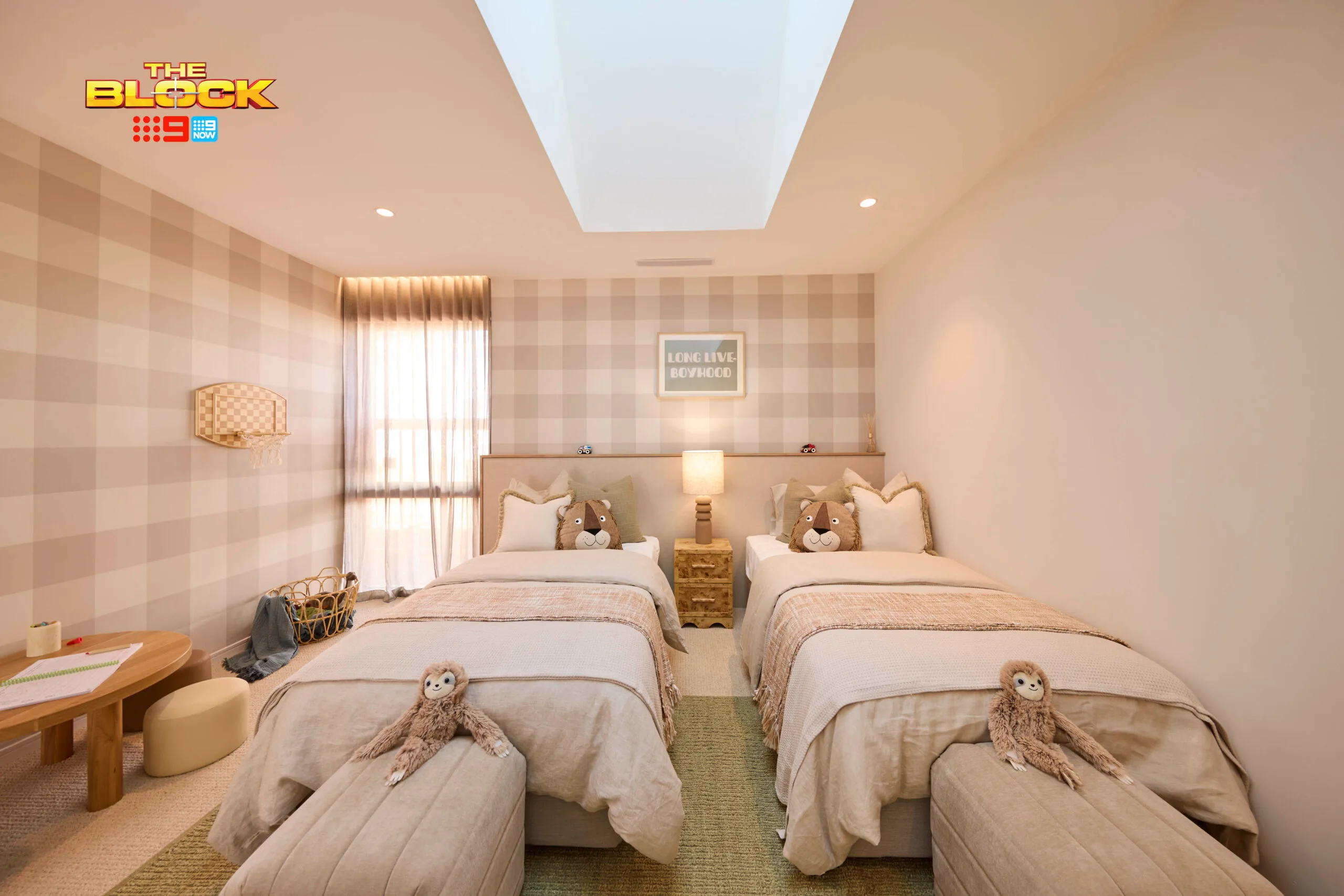 A plaid children's bedrooms with two twin beds. 