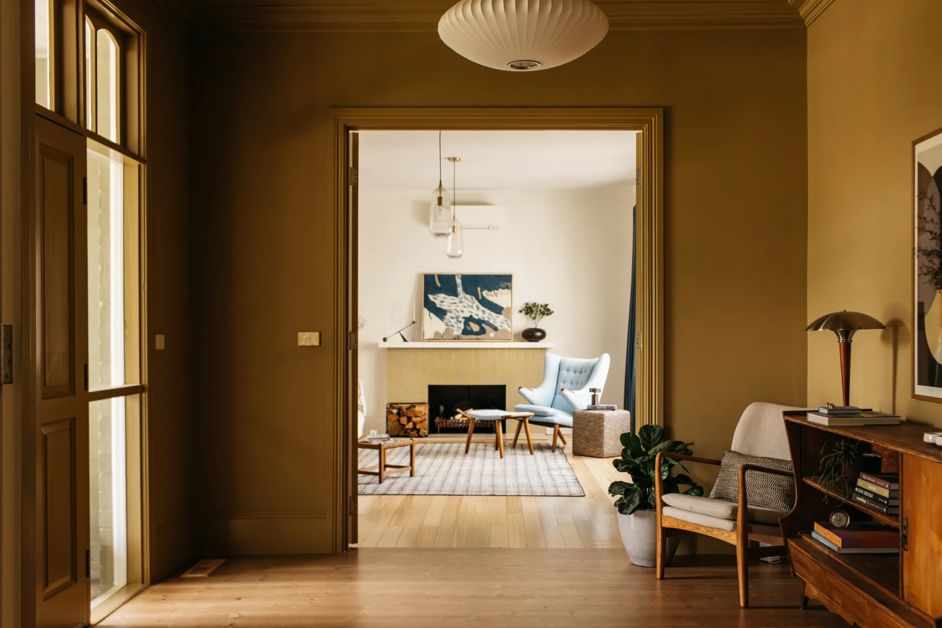 Heritage home featuring a Scandi-style entryway with a timber console and walls painted in Dulux Osso Bucco.