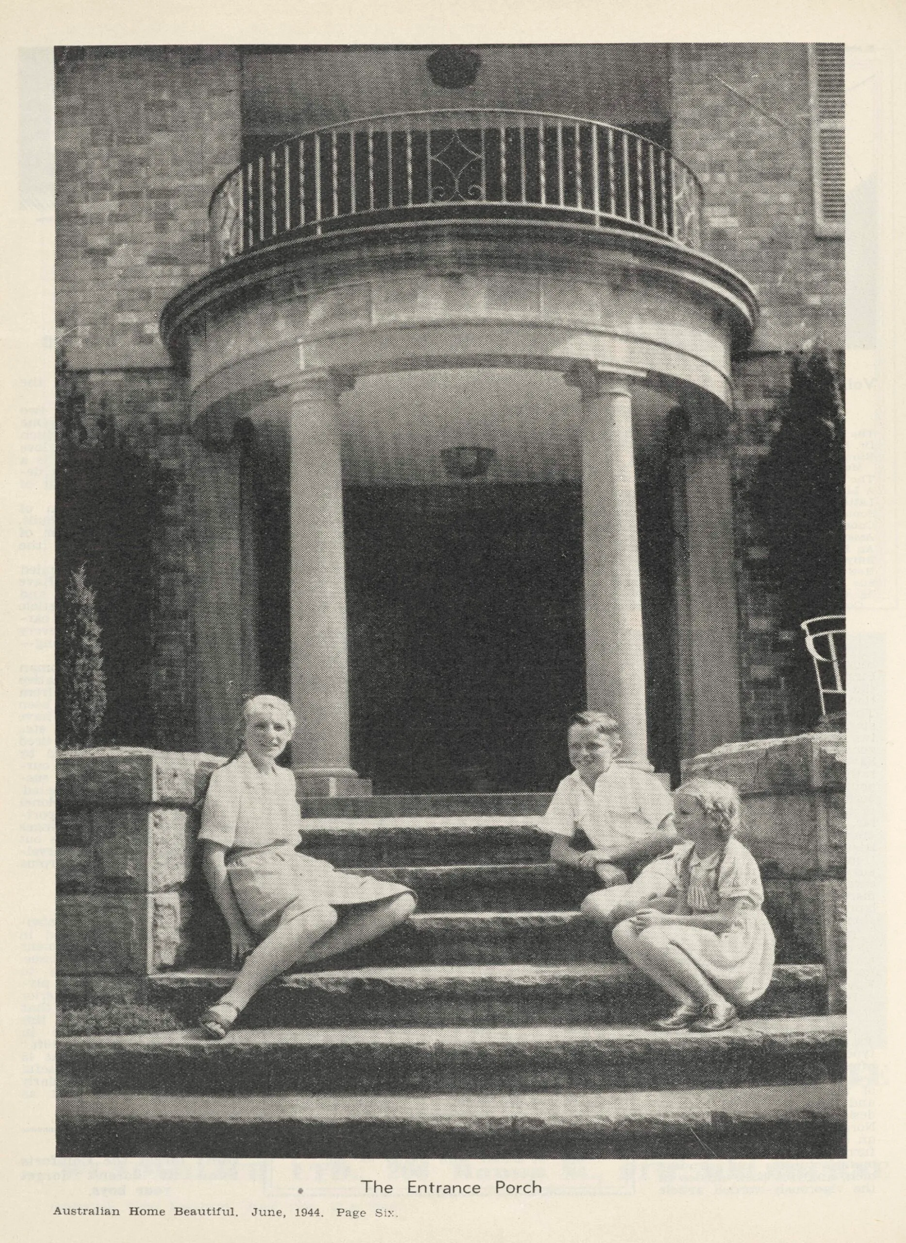 A scanned image of a black and white magazine page. Three children sit on stone steps in front of a large columned porch. Image from Australian Home Beautiful, June 1944