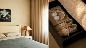 a cream bed frame with blue sheets and a storage compartment under the bed to store shoes, books and linens